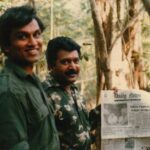 Prabhakaran Holding 'Daily News' Newspaper Featuring 'Prabhakaran Killed Rumour Sweeps the Country' (Below the Main Photo), Alongside PFLT General Secretary 'Yogi' Yogaratnam